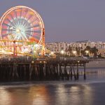 Santa monica pier at night with the ferris wheel lit with colorful lights