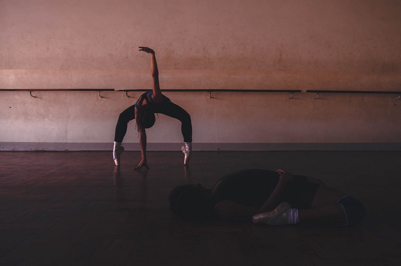 two dancers in a dimly lit studio