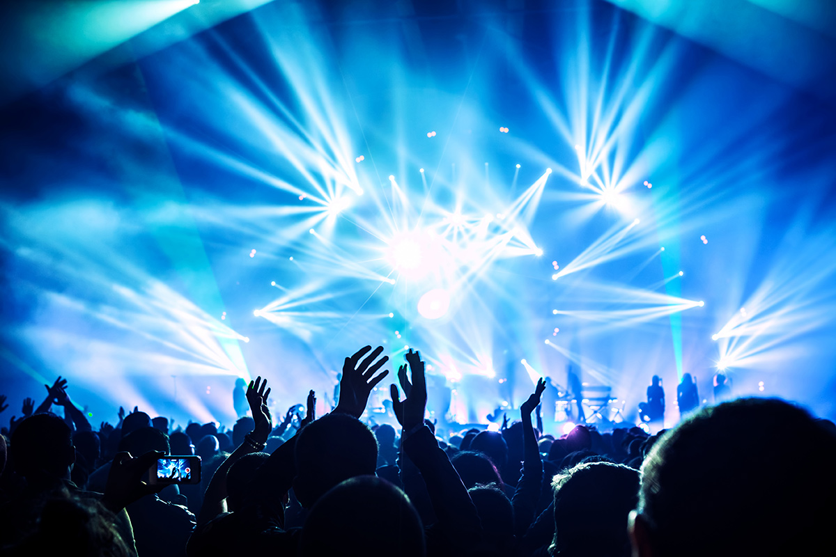 big crowd with hands in the air at a concert