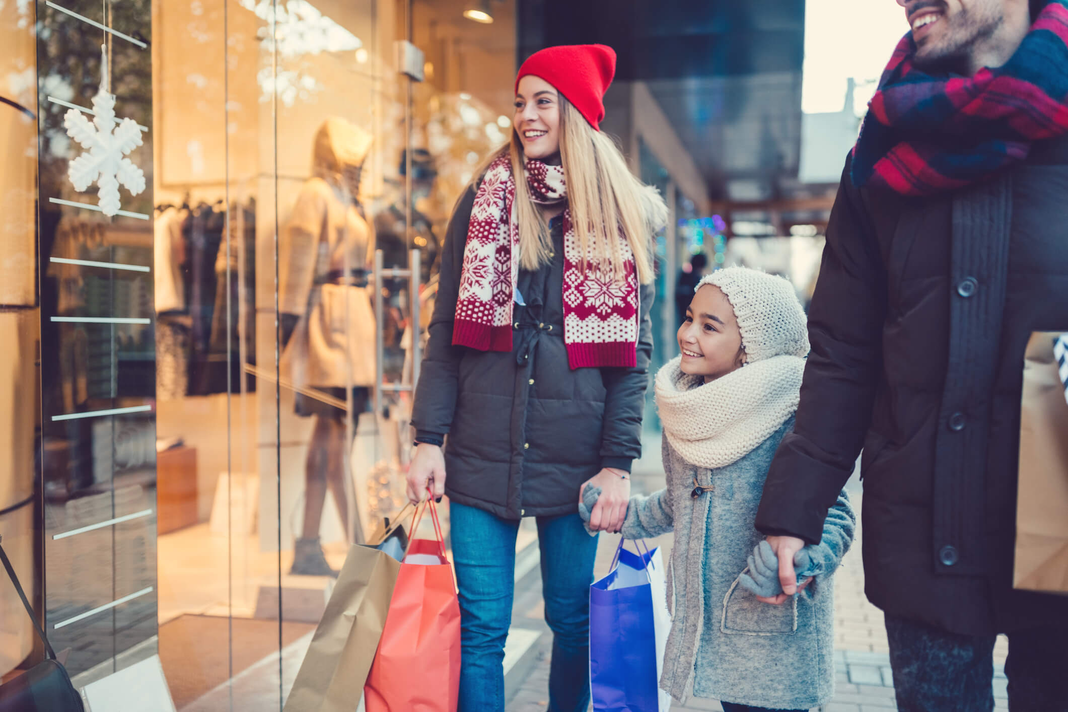 family bundled up shopping in the winter